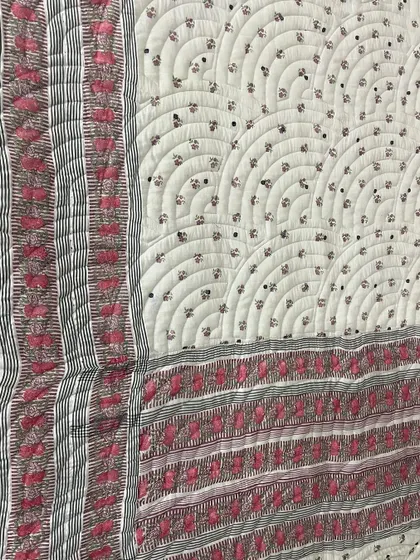 A collection of reversible memory quilts crafted from the sarees of a client's mother. Each side tells a different story, preserving the fabric's patterns and colors in a new, functional form.