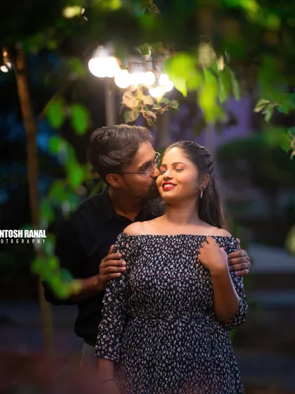A tender moment captured in the evening, with beautiful bokeh lighting creating a magical feel.