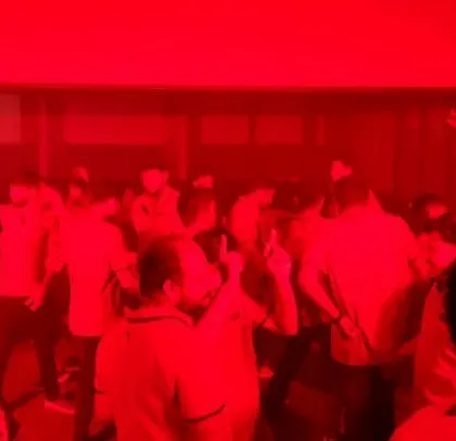 The room is bathed in intense red light.