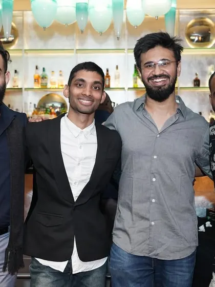A group of friends smiling together for a photo, capturing the strong sense of community at our events.
