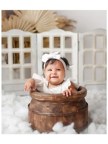 Another joyful shot from the white, cloud-themed milestone session.