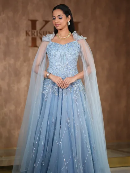 A modern, fashion-forward look featuring a pearl-encrusted gown. The simple diamond drop earrings are the perfect accessory for this statement outfit.