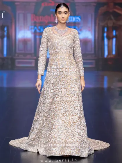 Dripping in elegance, drenched in glam. This breathtaking tail gown is a dream in cutwork and hand embellishments, crafted for the bride who owns the night.