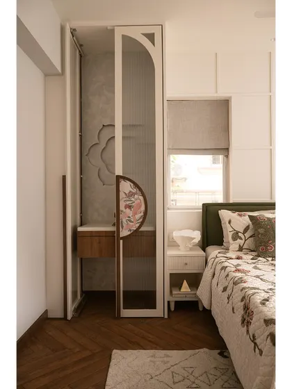 A full view of the guest bedroom with the mandir doors open. The design ensures that the sacred space feels like an integral part of the room, creating a harmonious environment for both rest and reflection.