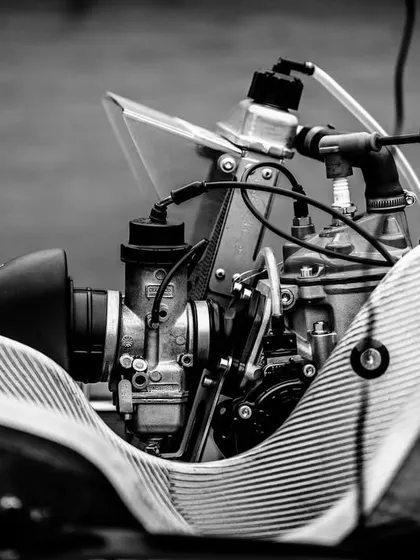 A black and white shot highlighting the intricate details of a Rotax engine and carburetor. The performance of these engines is key to success in the national championship.