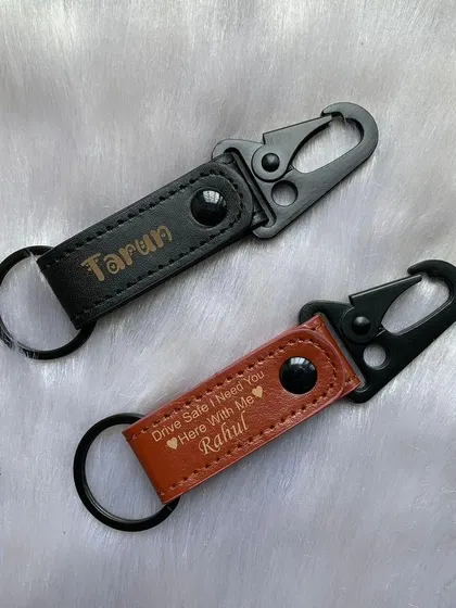 My Keychain 2.0 features a sturdy carabiner clip, making it easy to attach to bags or belt loops. Available in black and tan leather, I can engrave it with a name or a sweet message like 'Drive Safe'.
