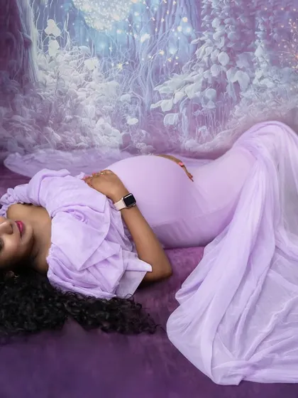 A dreamy, fairytale-inspired shot. This mom-to-be in a lavender gown looks like she's resting in an enchanted forest.