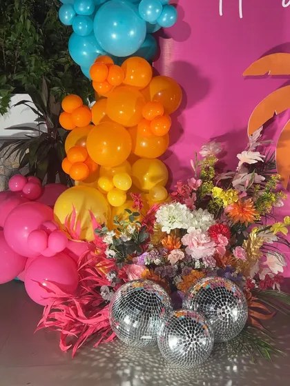 We added disco balls to the floral and balloon arrangements to bring a fun, party vibe to this tropical milestone celebration.