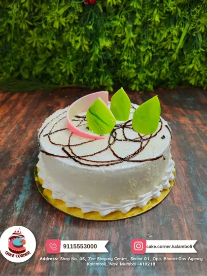 A light and refreshing coconut cake. The white frosting and green leaf accents give it a clean and tropical feel.