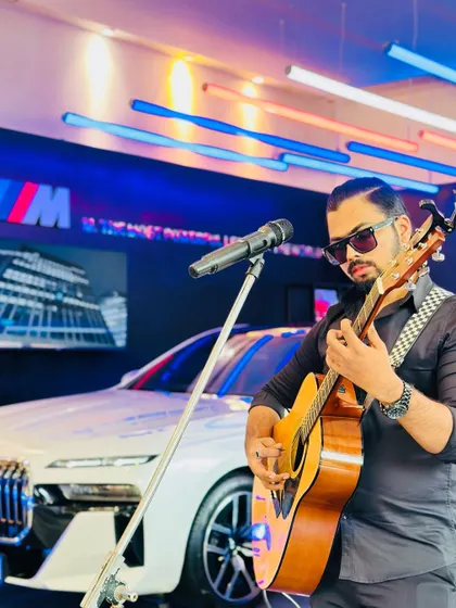 A focused shot while performing at the BMW i7 launch. The sleek design of the cars and the modern showroom lighting provided an amazing backdrop for the music.