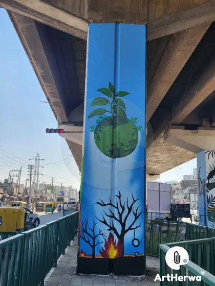 A powerful environmental message painted on a pillar, contrasting a dying, burning world with a new, green planet. We use public art to convey important social messages.