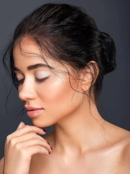A serene, eyes-closed version of the previous portrait. This pose emphasizes the soft, neutral tones of the makeup and the peaceful, elegant mood of the shoot.