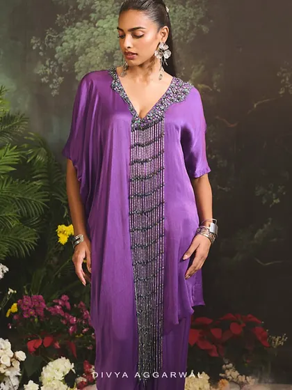 Immerse yourself in the intricacies of our Sage Kurta Set, featuring a draped skirt and a kurta with a heavily embellished neckline.