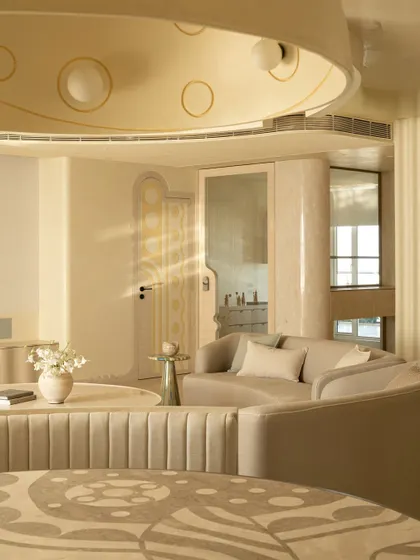 Sunlight catches the details of the Soft Serve dining area, from the patterned marble tabletop to the custom dome light and the fluted banquette seating.