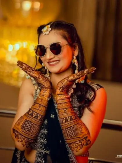 A cool and stylish bride showing off her mehndi with a pair of sunglasses. Your mehndi should reflect your personality!