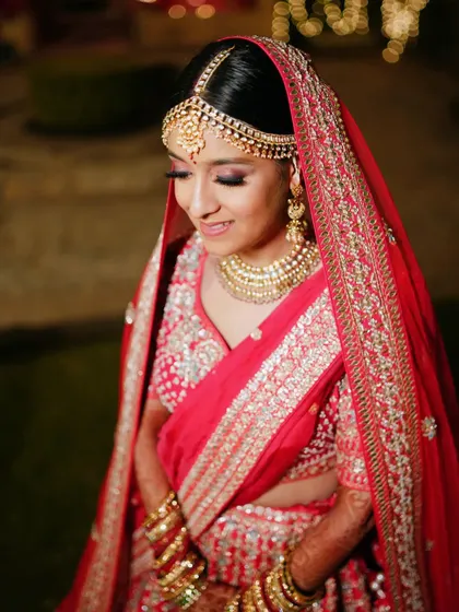 A classic bridal portrait focusing on the bride's serene expression and her stunning matha patti and necklace.