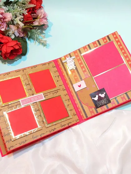 An inside page of the Valentine's scrapbook, with empty red frames ready to be filled with a couple's favorite photos.