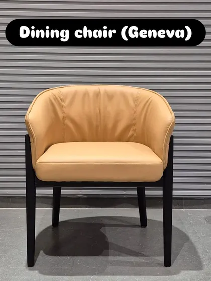 A front view of the 'Geneva' dining chair, highlighting its plush seat and enveloping backrest.