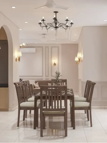 A classic dining room setup with a traditional wooden table and chairs. The space is defined by elegant wall molding, arched doorways, and classic chandeliers, creating a timeless and formal feel.