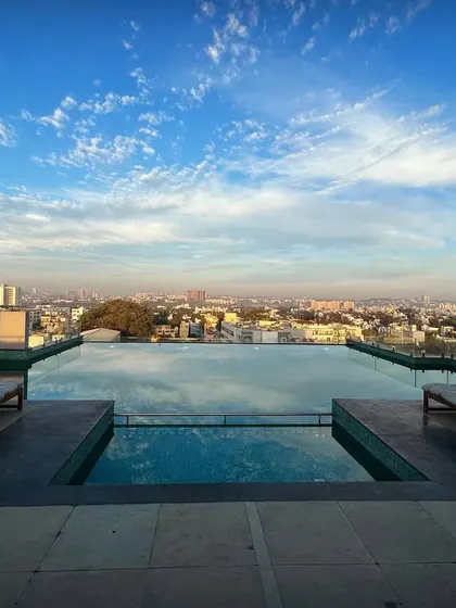 The rooftop infinity pool at the 'Treehouse' project offers panoramic views of the Bengaluru cityscape. This amenity is part of our strategy to deterritorialize the club and create unique social spaces.