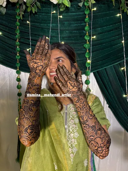 The best part of my job is seeing my clients happy. This full-arm floral mehendi was so much fun to create, and her smile says it all.