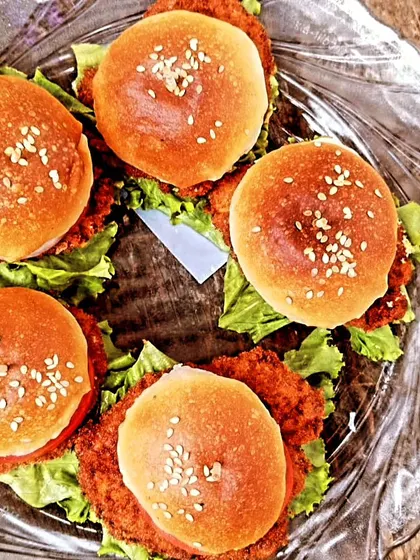 These chicken sliders are a consistent favorite for events. We ensure each one is assembled with fresh lettuce and a perfectly cooked patty.