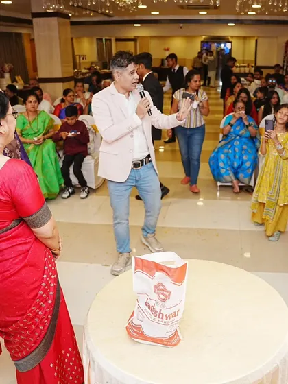 Addressing the guests at a baby shower, explaining the next activity and keeping the event flowing smoothly.