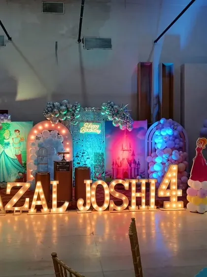 The full stage setup with chairs in the foreground, giving a sense of the event space and layout.