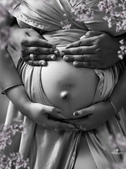 Sometimes, the most powerful stories are told in black and white. This artistic close-up focuses on the hands of the expecting parents cradling the baby bump, a simple and profound symbol of their growing love.