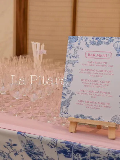 The bar menu for the baby shower, featuring cleverly named mocktails like 'Baby Bellini' and 'Blooming Flower G&T', all presented with the themed design.