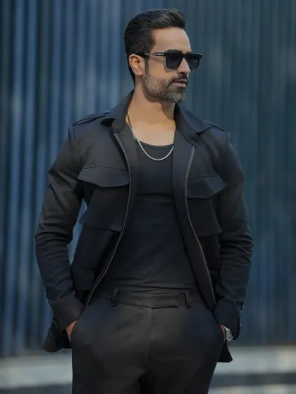 Another view of the black GT tracksuit, showcasing its sleek design and tailored fit.