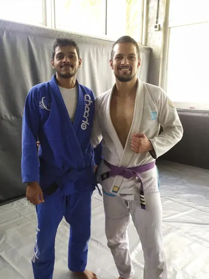 Posing with one of my coaches after getting promoted. Learning from experienced practitioners is key to growth in BJJ.