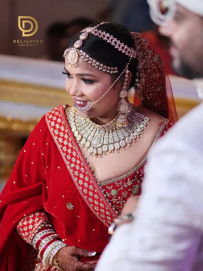 A candid shot of the bride's happy reaction upon seeing her groom. Her radiant smile and stunning diamond jewelry are the focus of this beautiful moment.