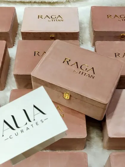Displaying the "Alia Curates" card alongside the custom-designed Titan Raga watch box. This project involved creating packaging that was both a beautiful product holder and a key piece of influencer marketing collateral.