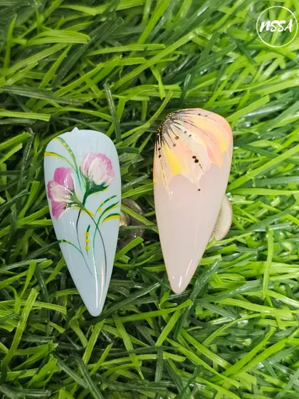 Beautiful floral nail art painted by our students. They learn to create depth and dimension using simple brush strokes and color blending techniques.