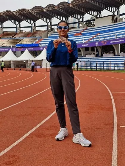 Holding my medal on the track after the Wipro Bengaluru Half Marathon. You don't just run, you lead.