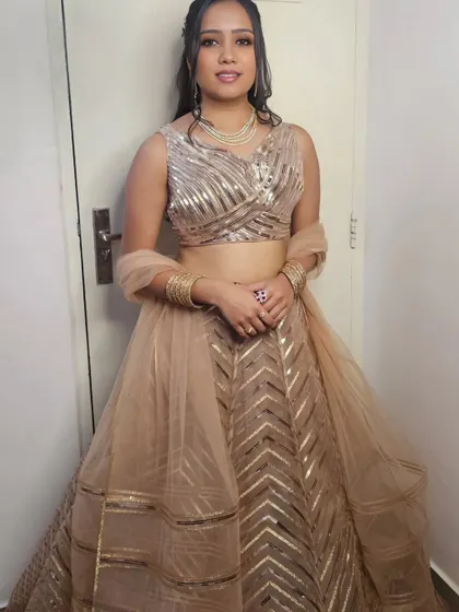 Anjali looking stunning in her shimmering gold lehenga for the 'Bane Bithai' ceremony.