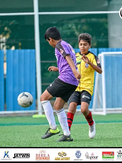 A player skillfully shielding the ball from an opponent in the final match.