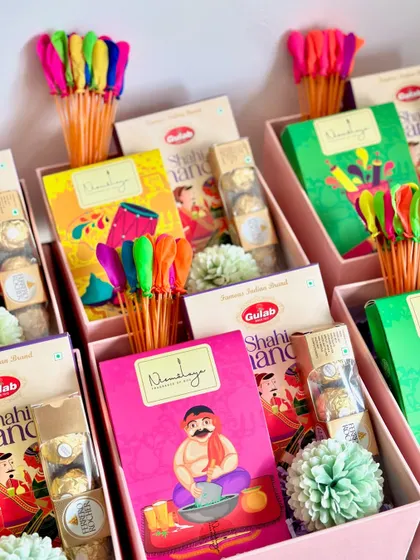 A closer look at our Holi return favors, showcasing the colorful herbal gulaal packets and other festive treats.