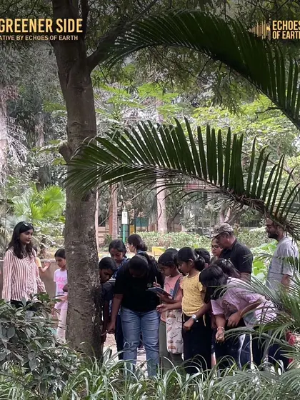 A group of young explorers gathered around a tree, keenly observing its features for their nature journals.