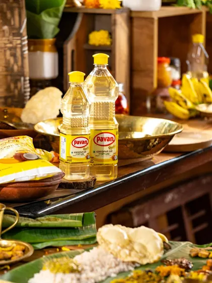A lifestyle shot showing bottles of cooking oil in a traditional kitchen setting, ready for the Onam feast preparation.