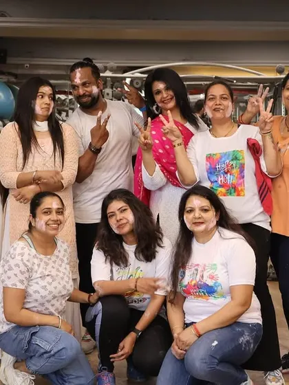 Victory signs and smiles all around during our fun-filled Holi party.