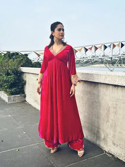 The beautiful texture of the velvet and the intricate sleeve embroidery are the stars of this look.