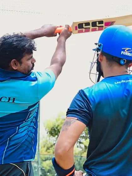 A close-up of a coach demonstrating the proper technique for a shot. This is the kind of expert guidance that makes a real difference.