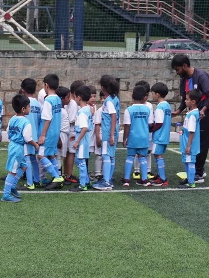 The little players listen to final instructions before taking the field for their U5 practice match.