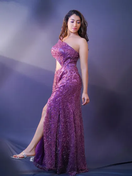 A dynamic pose from a model in a sparkling purple gown. This studio shot demonstrates my ability to capture movement and elegance in fashion photography.