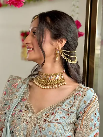A side profile highlighting the unique earring and hairstyle for this pre-wedding look.