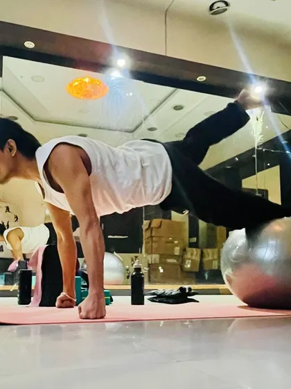 Using a stability ball for a challenging plank variation. This exercise intensely engages the core muscles for improved stability.
