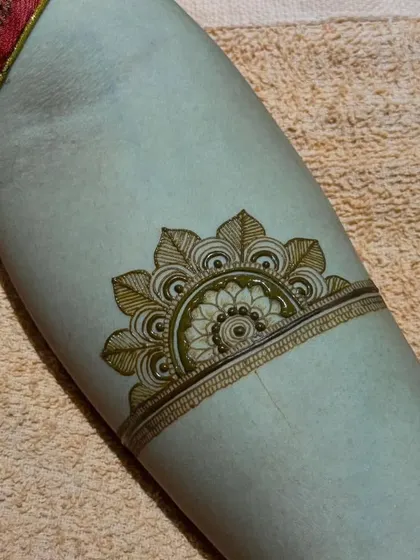 A minimalist leaf-style half-mandala arm band.