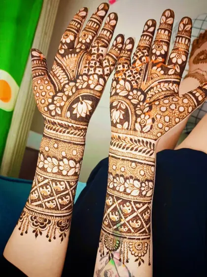 This full-coverage design features beautiful lotus motifs on the palms, surrounded by floral bands and delicate dot work.